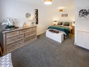 a bedroom with a bed and a dresser at No2 The Neuk in Belford