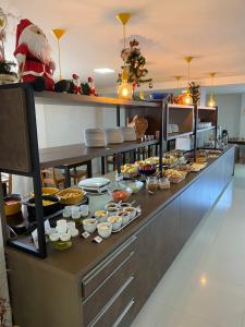 a buffet line with a lot of food on it at Hotel Jardim do Mar in Torres