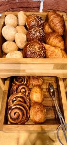 two wooden trays filled with different types of pastries at Europeum Hotel in Wrocław