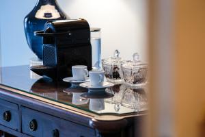 a glass counter top with cups and dishes on it at Dear Lisbon - Palace Chiado Suites in Lisbon +50 photos
