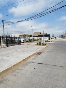 an empty street with a fence on the side of a road at Casa CQ in Coquimbo