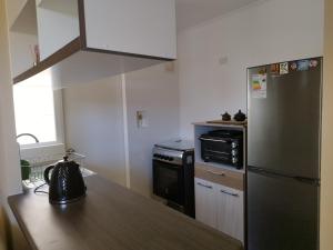 a kitchen with a stainless steel refrigerator and a stove at Casa CQ in Coquimbo