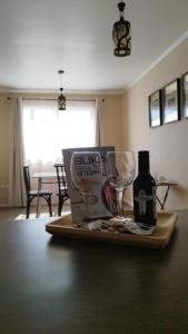 a tray with wine glasses and a bottle on a table at Casa CQ in Coquimbo