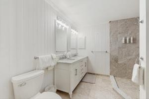 a white bathroom with a toilet and a sink at Stargazing Daydreamer in Arlington +45 photos