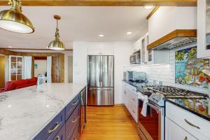 a kitchen with white counter tops and blue cabinets at Carolyn's Dream in Oceanside
