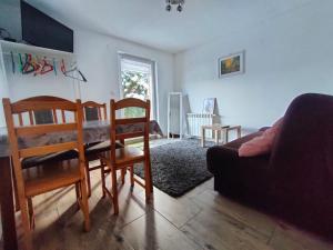 a living room with a couch and a table and chairs at Czaple znad popradu in Piwniczna-Zdrój