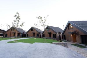 a group of houses with a lawn in front of them at Lyv Resort and Venue in Şannīn
