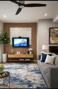 a living room with a couch and a flat screen tv at Ekhaya in Hartbeespoort