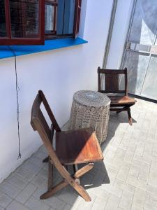 a wooden chair sitting next to a table at 52 Maroela street in Mossel Bay