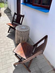 a wooden chair and a table next to a building at 52 Maroela street in Mossel Bay