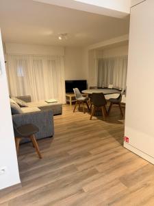 a living room with a table and chairs at De Haan App 1 in De Haan +3 photos