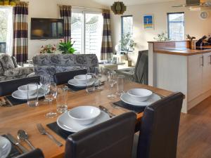 a dining room table with plates and glasses on it at Highview in North Walsham