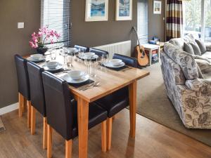 a dining room table with black chairs and a dining room at Highview in North Walsham
