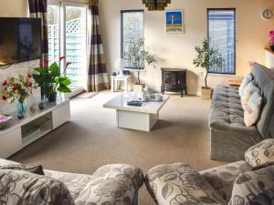 a living room with a couch and a table at Highview in North Walsham