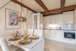 a kitchen with a table with two plates on it at Hellandsøy apartment, Henningsvær in Henningsvær