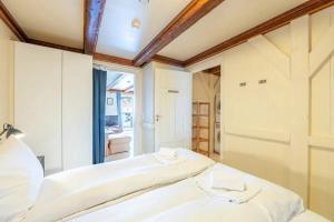 a bedroom with two beds and a large window at Hellandsøy apartment, Henningsvær in Henningsvær