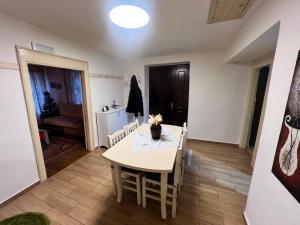 a dining room with a white table and chairs at Vila Korcari Dardhe in Dardhë