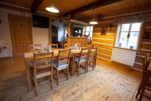a dining room with a wooden table and chairs at Penzion Modrý Pavilon in Dolní Malá Úpa +21 photos