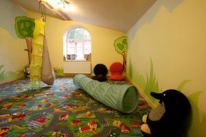 a childs room with a play area with a bed and a cat at Penzion Modrý Pavilon in Dolní Malá Úpa