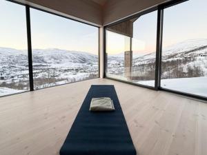 a room with a yoga mat in front of windows at New Cabin With Panoramic Views At Hardangervidda in Eidfjord