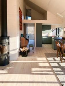 a kitchen and living room with a stove in a house at New Cabin With Panoramic Views At Hardangervidda in Eidfjord +23 photos