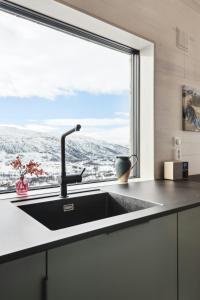 a kitchen with a sink and a large window at New Cabin With Panoramic Views At Hardangervidda in Eidfjord