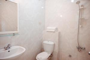 a bathroom with a toilet and a sink and a shower at Smouha Hotel in Alexandria +17 photos