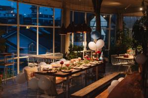 a long table in a room with balloons and candles at The LOOP Boutique Hotel & Café in Da Lat