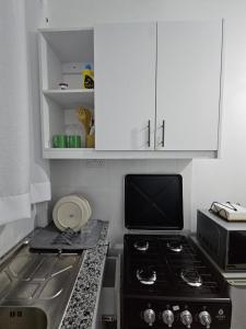 a kitchen with a stove and a microwave at Upscale homes in Ongata Rongai 
