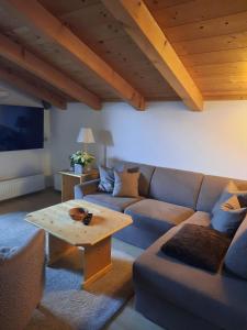 a living room with a couch and a coffee table at Haus Gmahblick Appartments in Alpbach