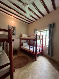 a room with two bunk beds and a window at Msafiri House in Kizimkazi