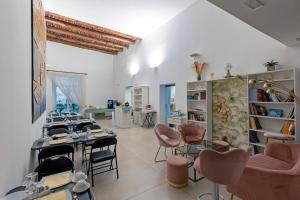 a salon with tables and chairs in a room at Il Tesoro Smart Suite & SPA in Naples