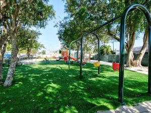 a park with a playground with a swing set at Courtside Villa at Key Largo in Key Largo