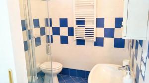 a blue and white bathroom with a toilet and a sink at Villa Mary - Apartment in Trani +19 photos