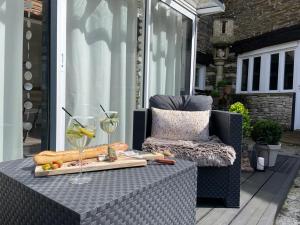 a table with a tray of food and a glass of wine at Charmant Studio in Le Breuil-en-Bessin