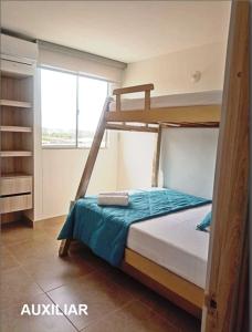 a bedroom with two bunk beds and a window at Capriella,Cartagena in Cartagena de Indias +5 photos