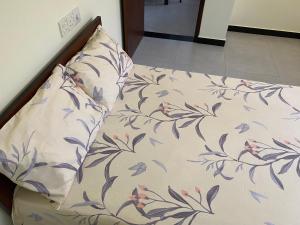 a bed with a pillow and apillow at Peacock Residence in Dickwella