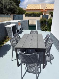 a wooden table and chairs on a patio at Beach Relax Apartment in Porto Santo