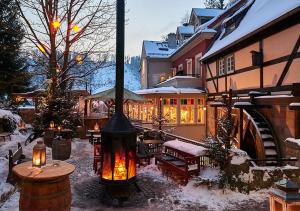a house with a large fireplace in the snow at Eine gemütliche Ferienwohnung in Kurort Gohrisch