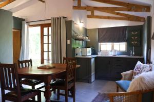 a kitchen with a table and a dining room at Stonehaven Clarens in Clarens