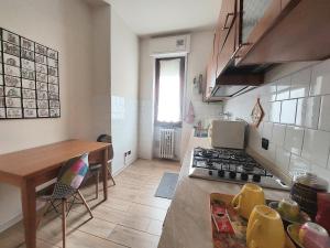 a kitchen with a table and a stove top oven at Grazioso Bilocale in Busto Arsizio