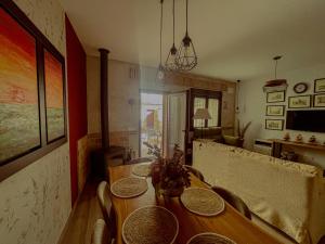 a dining room with a wooden table and chairs at Casa Sol del Prado, Cerca De Puy Du Fou in Guadamur