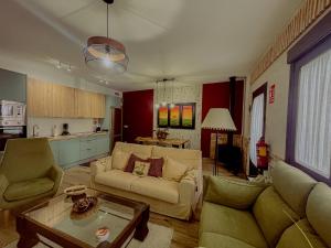 a living room with a couch and a table at Casa Sol del Prado, Cerca De Puy Du Fou in Guadamur +25 photos