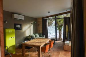 a living room with a wooden table and a couch at Chez Oreste - Escapade à 2 avec sauna et jardin clos in Aywaille