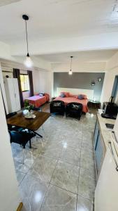 a large living room with a bed and a table at Monoambiente Eldorado 6 in Eldorado