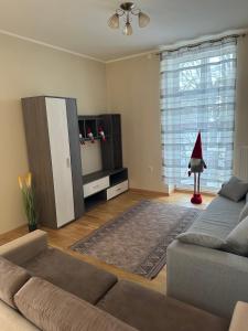 a living room with a couch and a entertainment center at SUNNY holidays in Liepāja