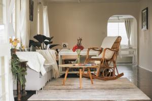 a living room with two chairs and a table at Nostalgia Villa Dalat in Ấp Ða Lợi