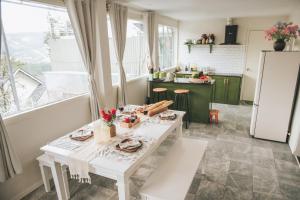 a kitchen with a white table and a white refrigerator at Nostalgia Villa Dalat in Ấp Ða Lợi +36 photos