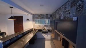 a bathroom with a counter and a sink in it at Mirante Rota do Mar in Maceió