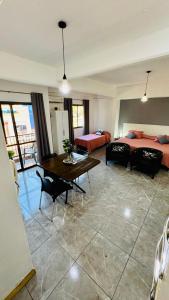 a bedroom with two beds and a table in a room at Monoambiente Eldorado 6 in Eldorado